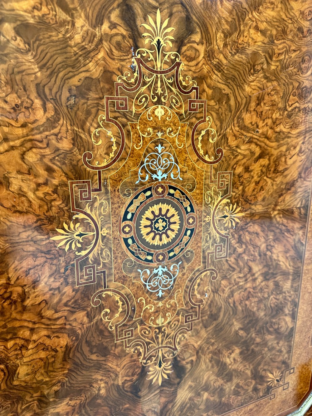 A Victorian burr walnut credenza sideboard featuring intricate marquetry inlay, a central panelled cupboard door, two curved glass display doors, and gilt brass mounts. View VII