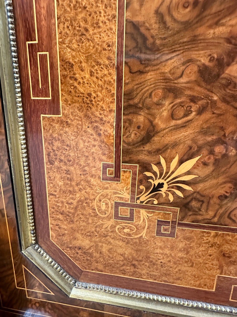 A Victorian burr walnut credenza sideboard featuring intricate marquetry inlay, a central panelled cupboard door, two curved glass display doors, and gilt brass mounts. View IX