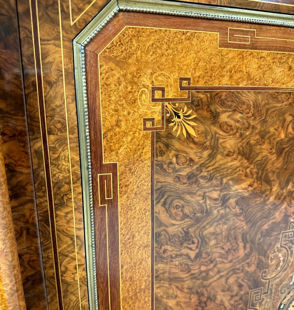 A Victorian burr walnut credenza sideboard featuring intricate marquetry inlay, a central panelled cupboard door, two curved glass display doors, and gilt brass mounts. View X