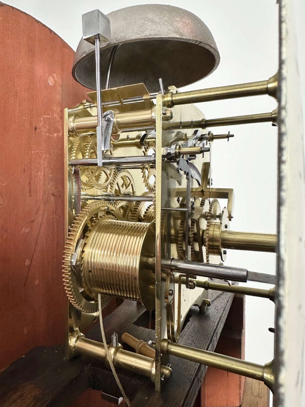 A Georgian tall mahogany longcase clock featuring an arched hood, a circular dial with Roman numerals, and brass fluted quarter columns. View III