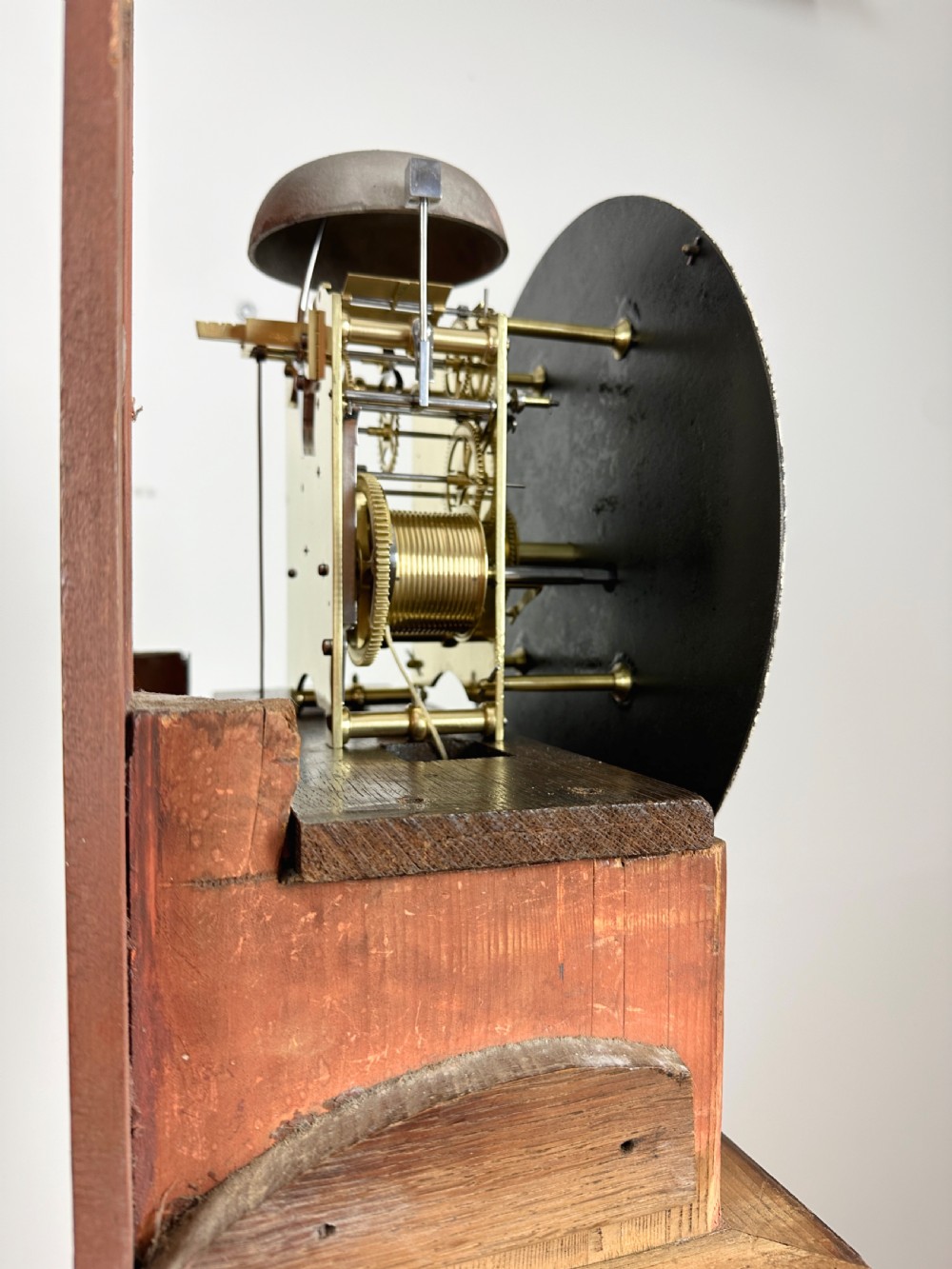 A Georgian tall mahogany longcase clock featuring an arched hood, a circular dial with Roman numerals, and brass fluted quarter columns. View IV