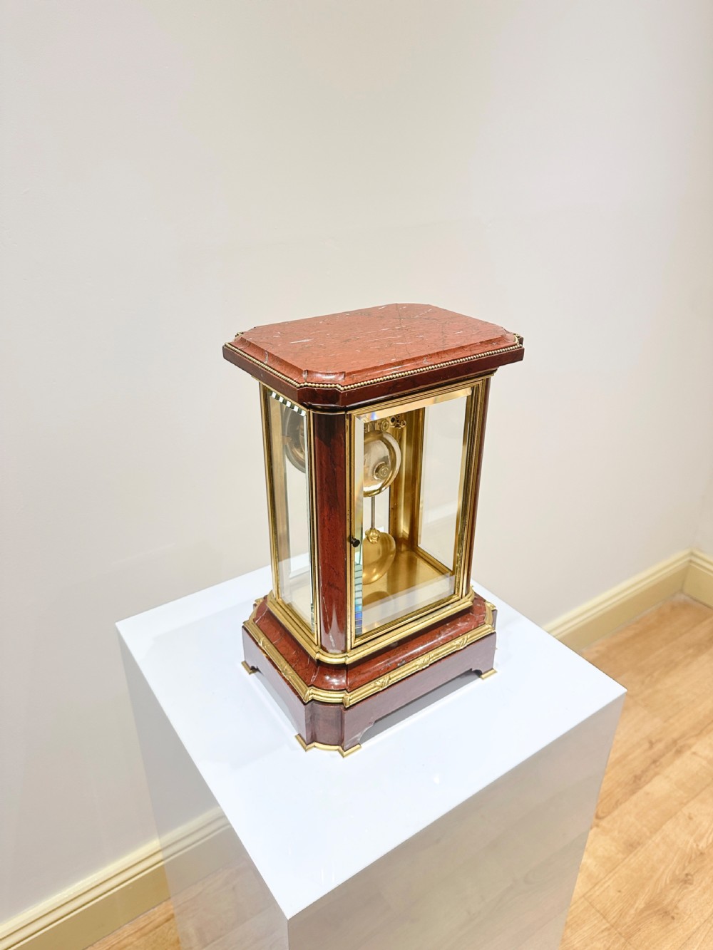 A French four-glass mantel clock featuring a rouge marble top and base, gilt ormolu mounts, a ribbon bow crest, and an enamel dial signed Le Roy & Fils. View III