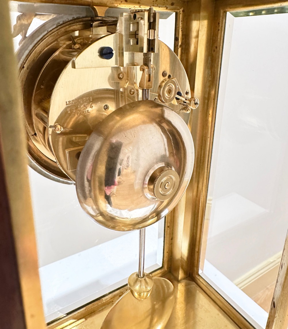 A French four-glass mantel clock featuring a rouge marble top and base, gilt ormolu mounts, a ribbon bow crest, and an enamel dial signed Le Roy & Fils. View IV