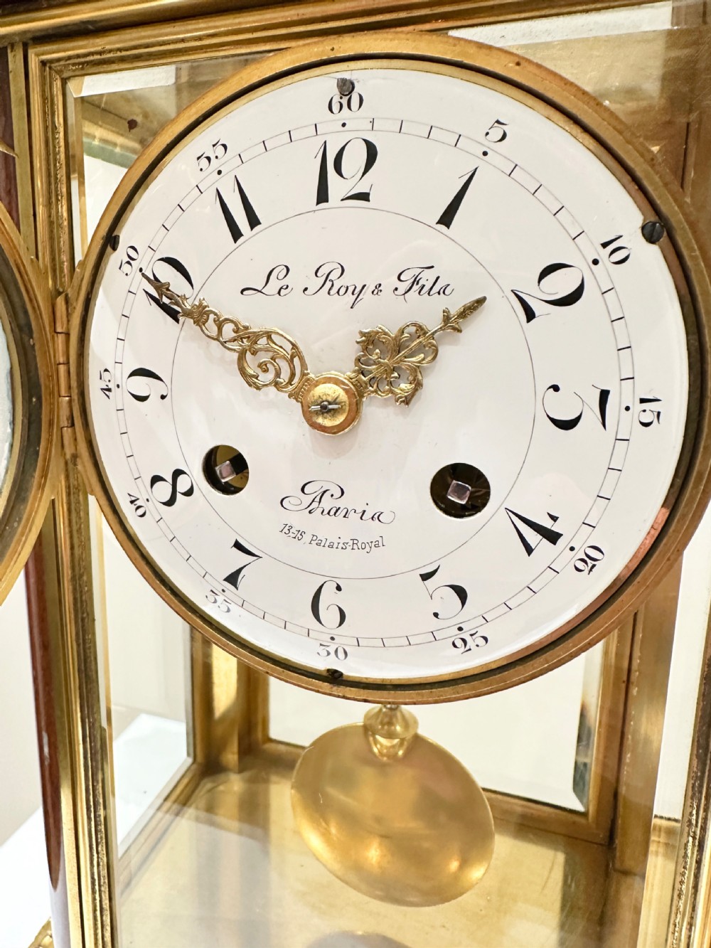 A French four-glass mantel clock featuring a rouge marble top and base, gilt ormolu mounts, a ribbon bow crest, and an enamel dial signed Le Roy & Fils. View VII