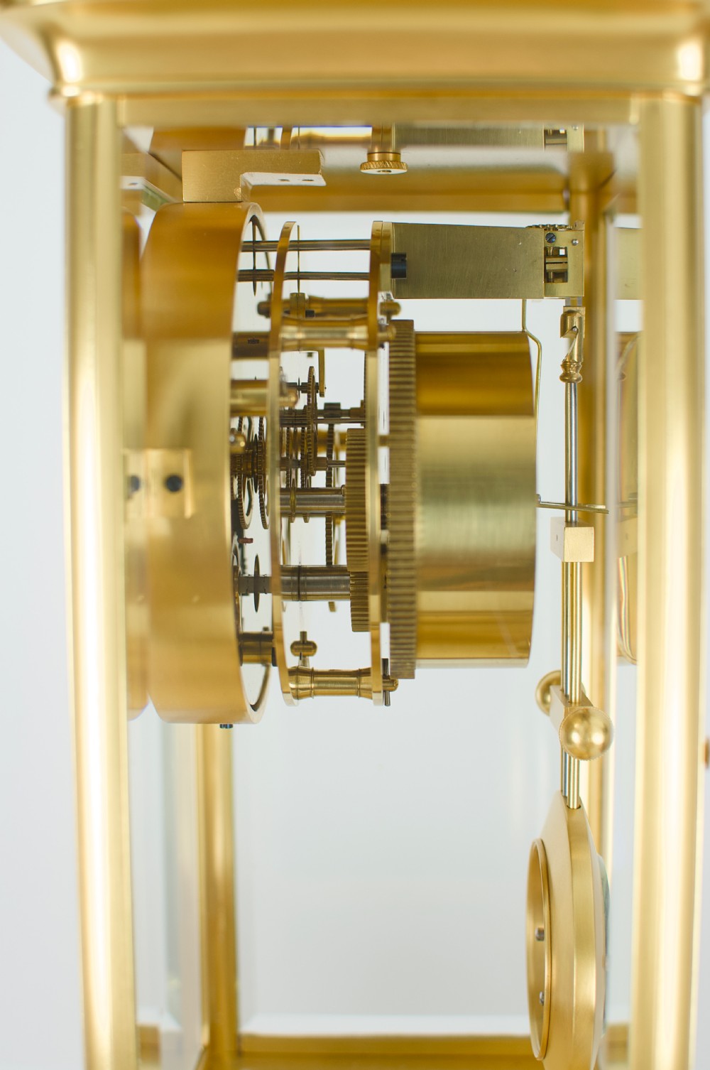 A nineteenth-century French four-glass mantel clock with a gilt brass case, white enamel dial with Roman numerals, exposed Brocot escapement, and visible pendulum. View VIII