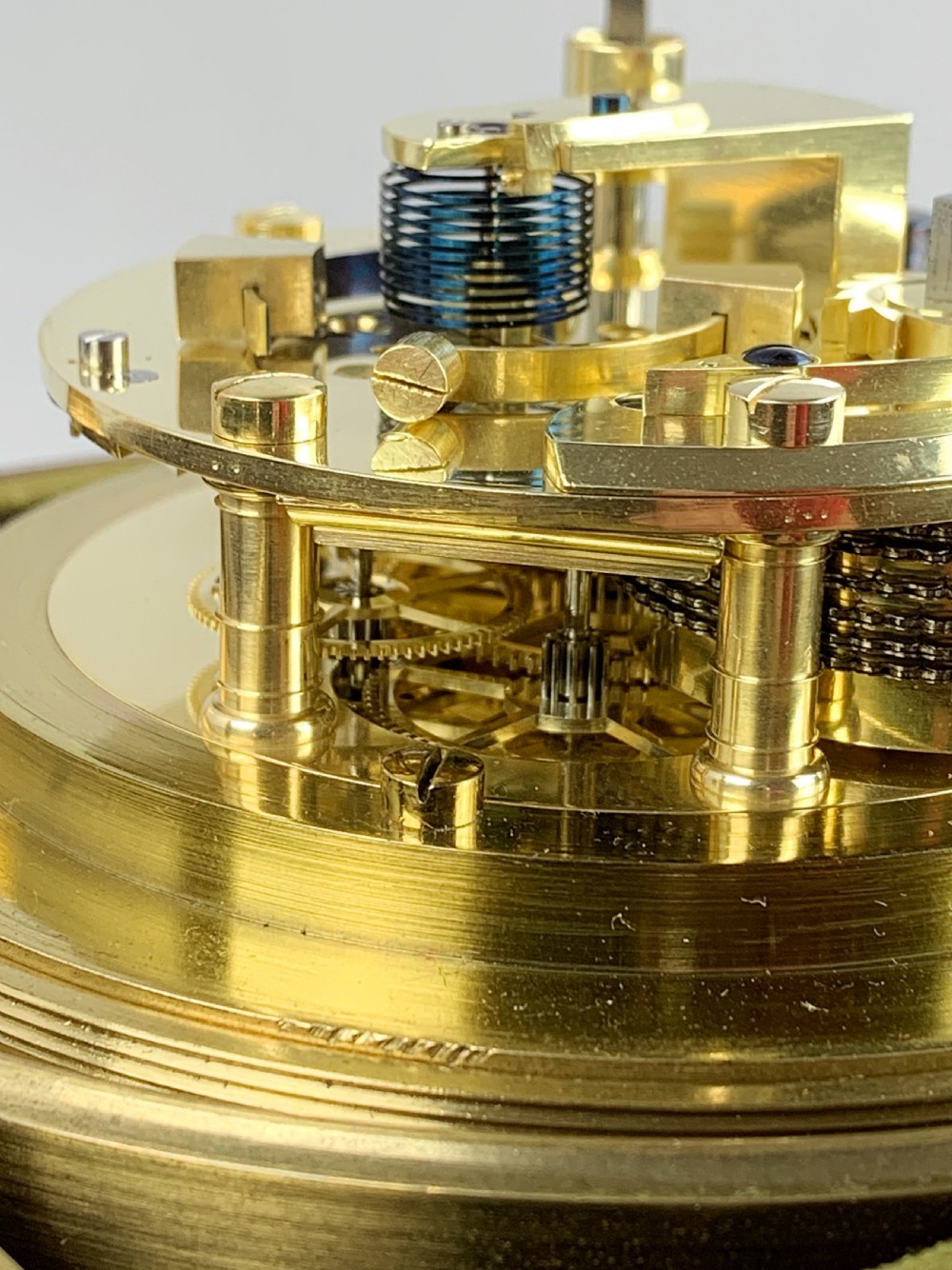 An antique 19th-century brass-bound wooden box opening to reveal a gimballed marine chronometer clock with a silvered dial and Roman numerals. View V