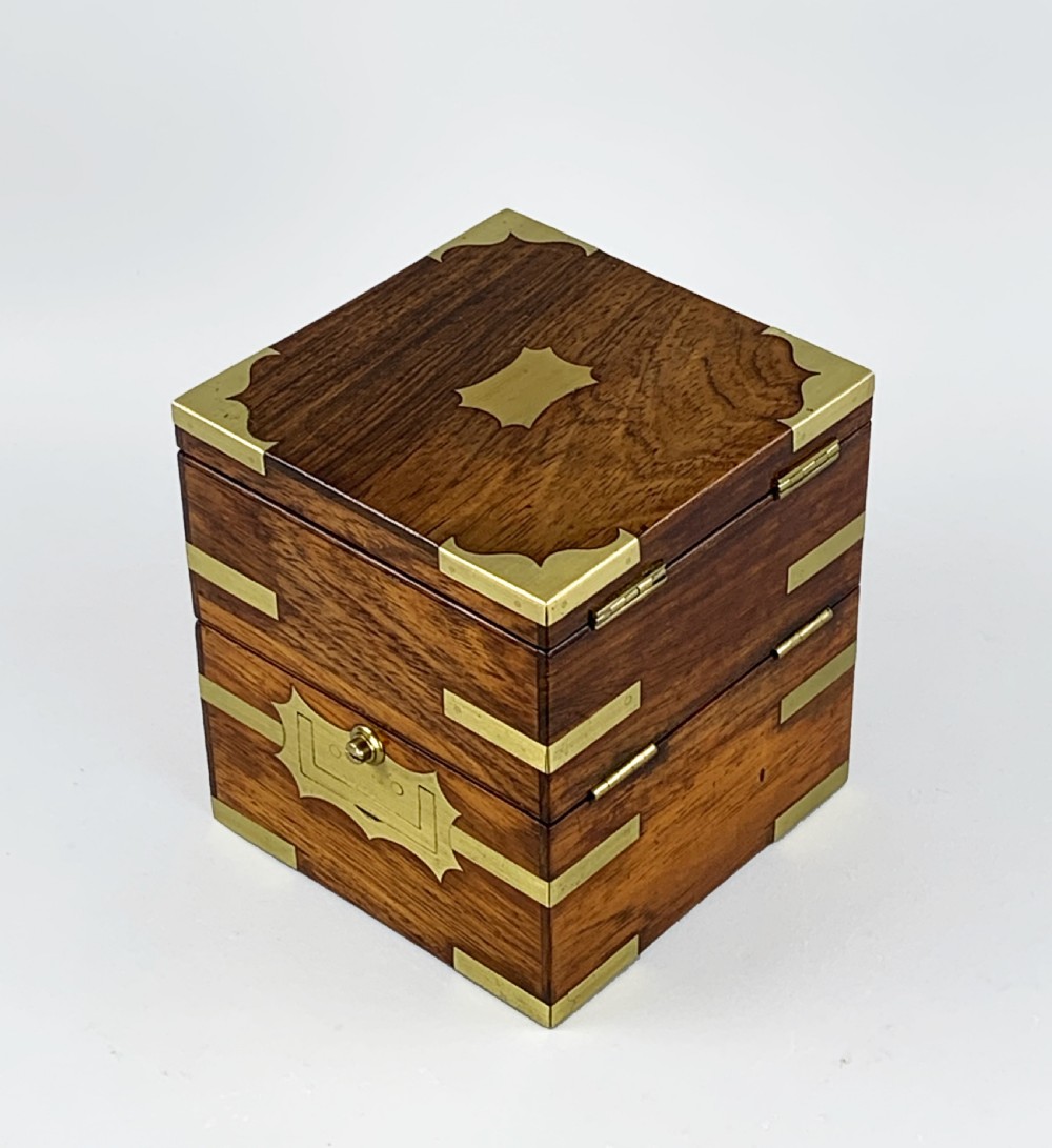 An antique 19th-century brass-bound wooden box opening to reveal a gimballed marine chronometer clock with a silvered dial and Roman numerals. View XVII