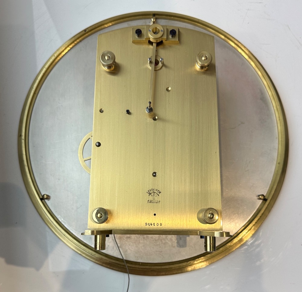 An Edwardian Lenzkirch precision regulator longcase clock housed in a dark walnut case featuring a silvered dial and glazed door revealing a brass pendulum. View III