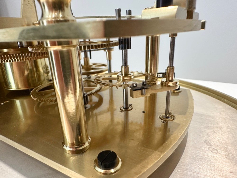An Edwardian Lenzkirch precision regulator longcase clock housed in a dark walnut case featuring a silvered dial and glazed door revealing a brass pendulum. View VII
