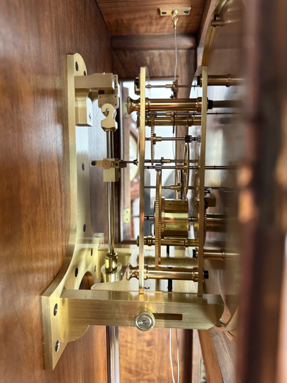 An Edwardian Lenzkirch precision regulator longcase clock housed in a dark walnut case featuring a silvered dial and glazed door revealing a brass pendulum. View IX