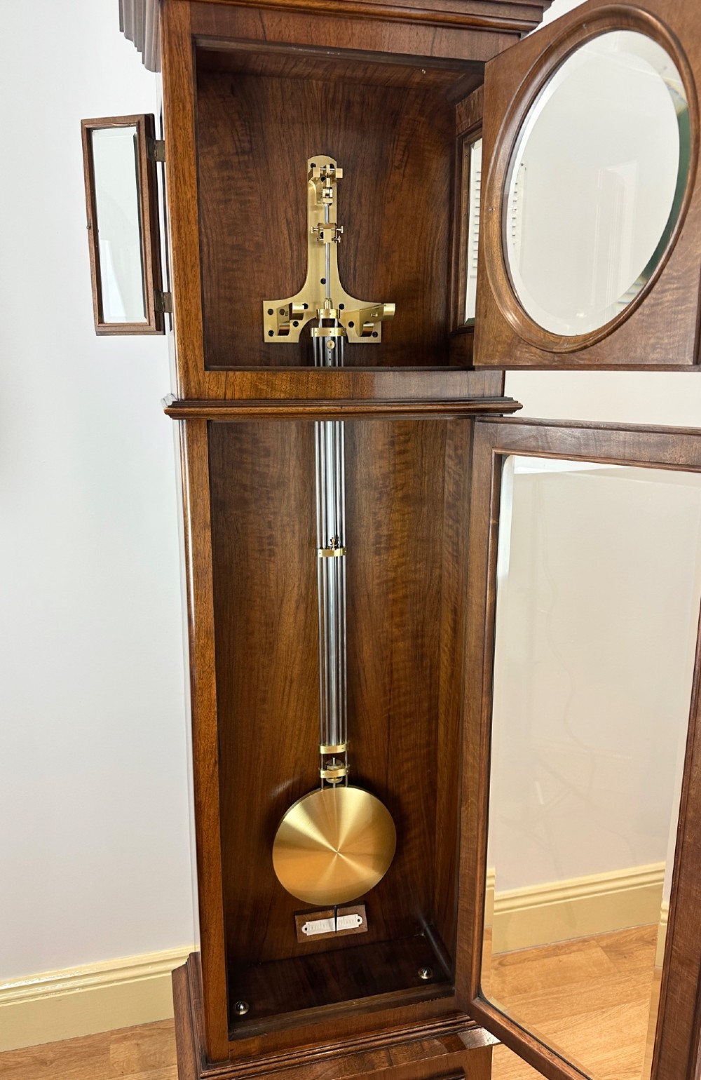 An Edwardian Lenzkirch precision regulator longcase clock housed in a dark walnut case featuring a silvered dial and glazed door revealing a brass pendulum. View X
