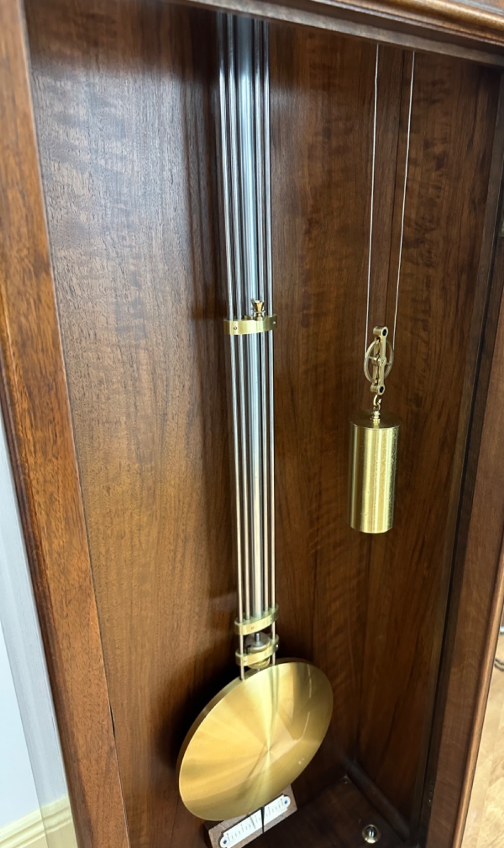 An Edwardian Lenzkirch precision regulator longcase clock housed in a dark walnut case featuring a silvered dial and glazed door revealing a brass pendulum. View XII