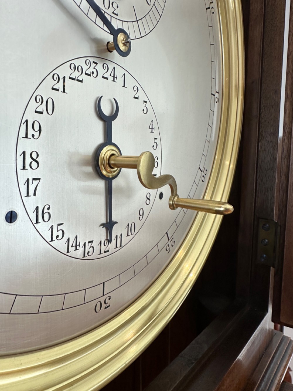 An Edwardian Lenzkirch precision regulator longcase clock housed in a dark walnut case featuring a silvered dial and glazed door revealing a brass pendulum. View XIII