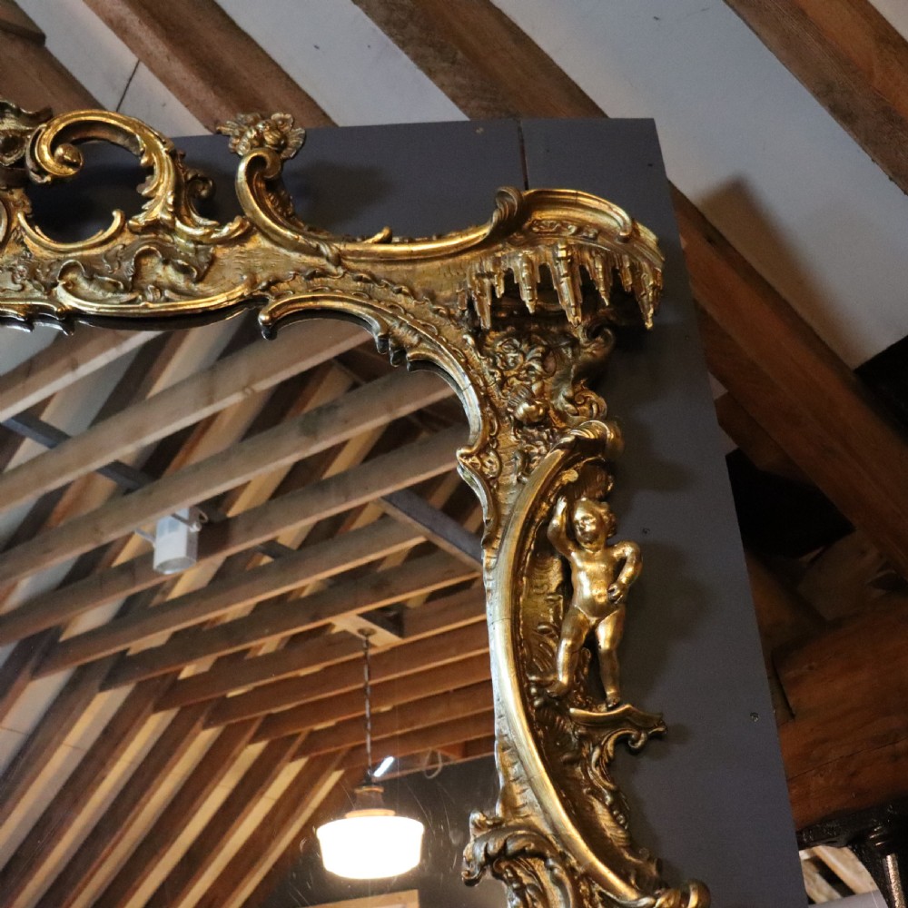 A large Rococo giltwood wall mirror featuring asymmetrical scrollwork, acanthus leaves, and carved ho-ho bird motifs. View IV