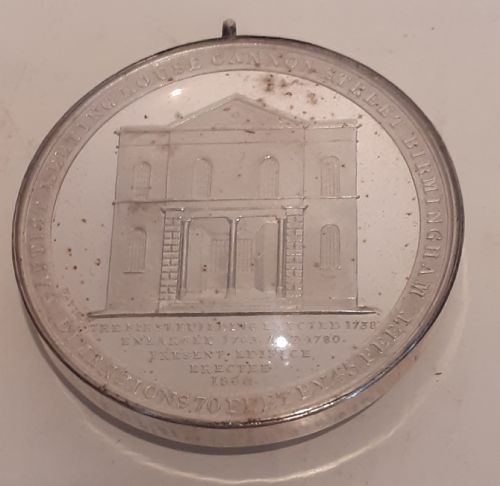 fig 1. A circular Victorian silver commemorative medal featuring an engraved architectural scene, housed in a velvet-lined Goldsmiths presentation case.