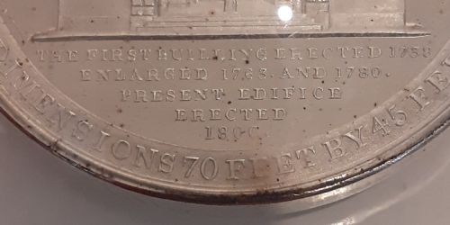 fig 3. A circular Victorian silver commemorative medal featuring an engraved architectural scene, housed in a velvet-lined Goldsmiths presentation case.