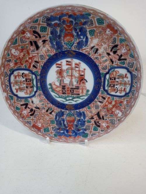 fig 2. A four-piece Japanese Imari porcelain set featuring three patterned display plates and a matching small bowl decorated with European ship motifs in red, blue, and gold.