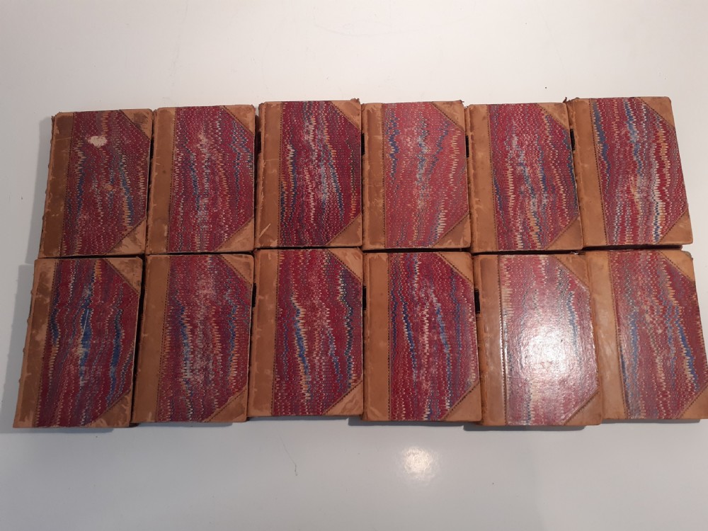 A twelve-volume set of 1856 Shakespeare books bound in tan leather with gilt-tooled floral motifs and black title labels. View II