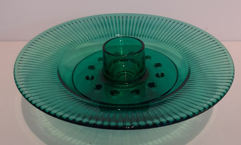 An Art Deco green pressed glass rose bowl featuring a wide fluted rim and a removable perforated central flower frog.