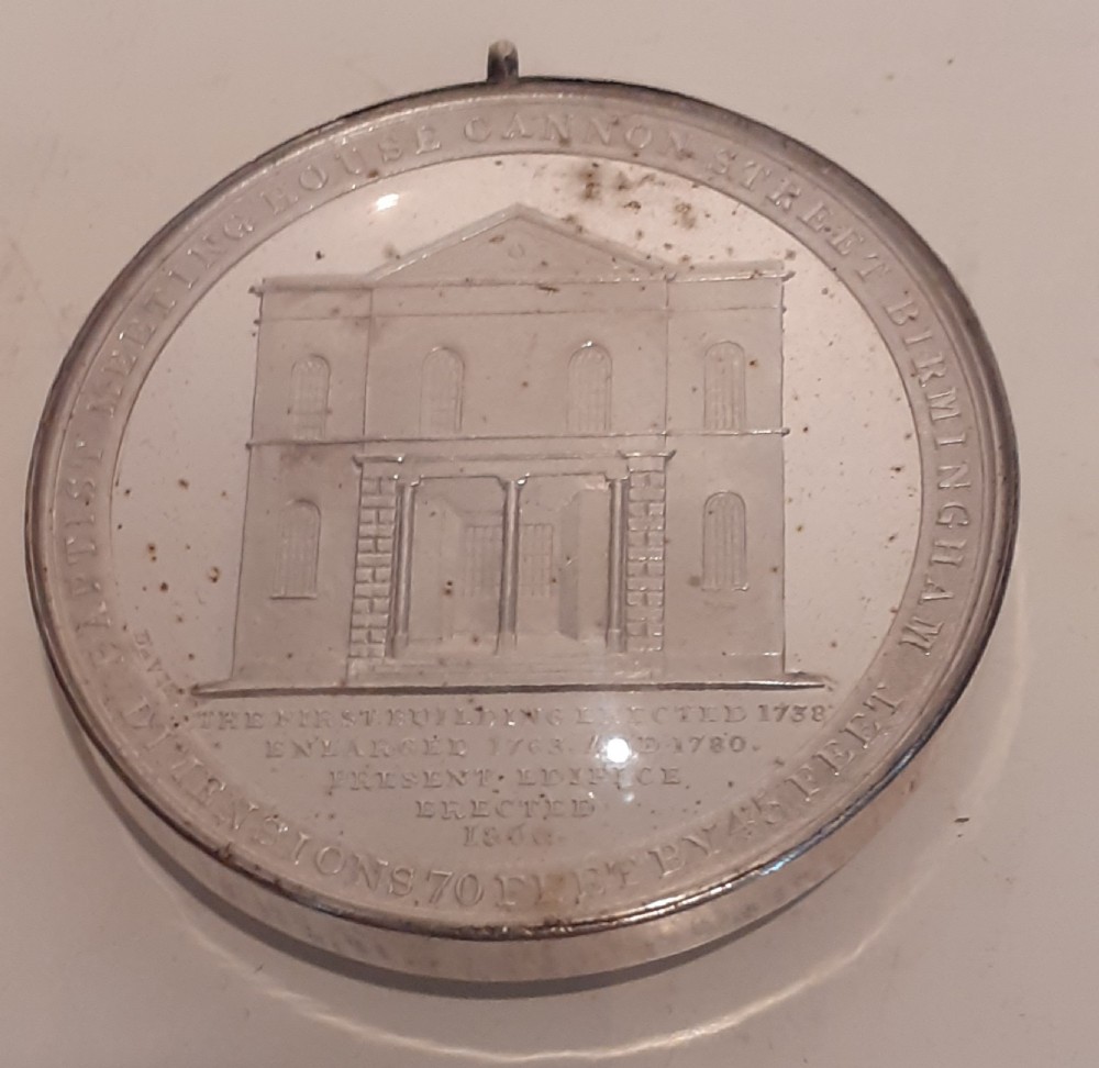 A circular Victorian silver commemorative medal featuring an engraved architectural scene, housed in a velvet-lined Goldsmiths presentation case. View II