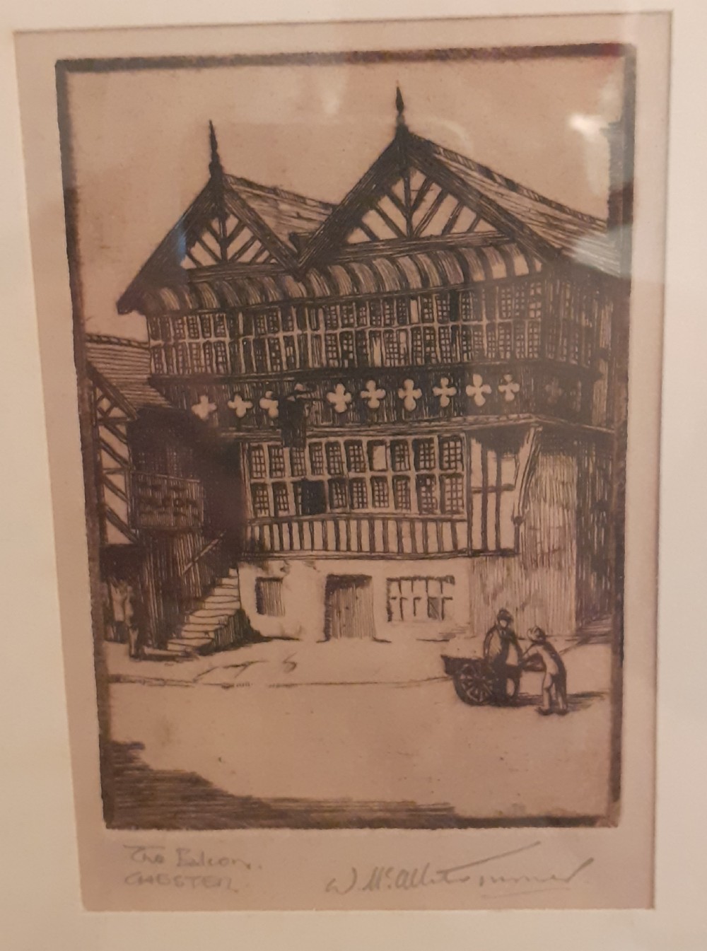 A framed monochrome etching depicting the historic timber-framed Falcon building in Chester, presented within a light cream mount and slim black wooden frame. View II