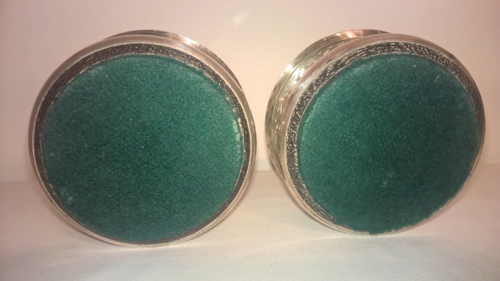 A pair of circular silver-plated wine coasters featuring pierced gallery sides, beaded borders, and turned hardwood bases. View III