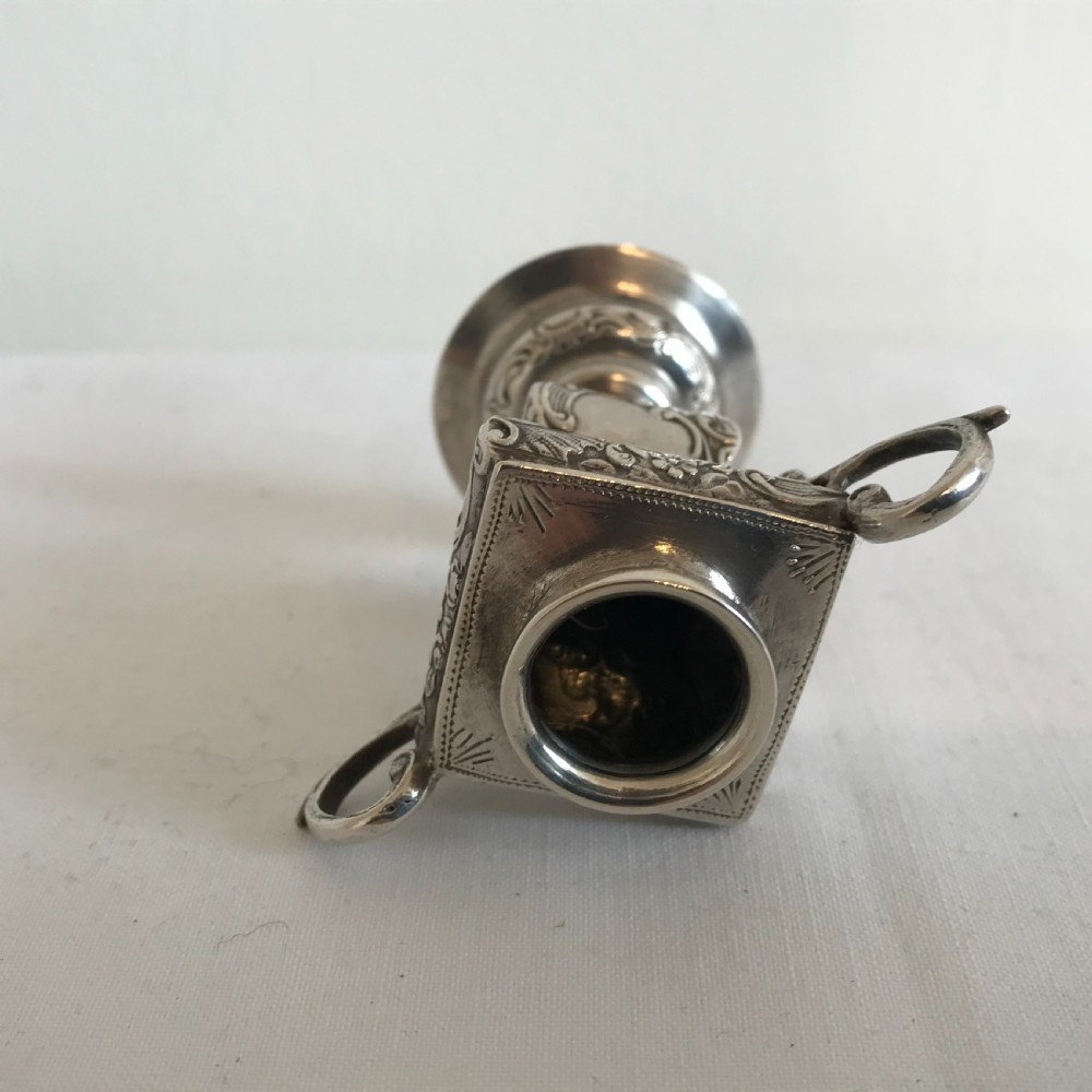 An ornate German silver miniature urn vase featuring scrolled handles, floral relief chasing, and a circular pedestal base. View III