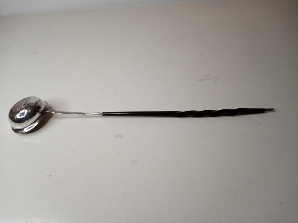 A Georgian silver toddy ladle bowl with an inset George III silver coin at the centre and a reeded handle joint. View III