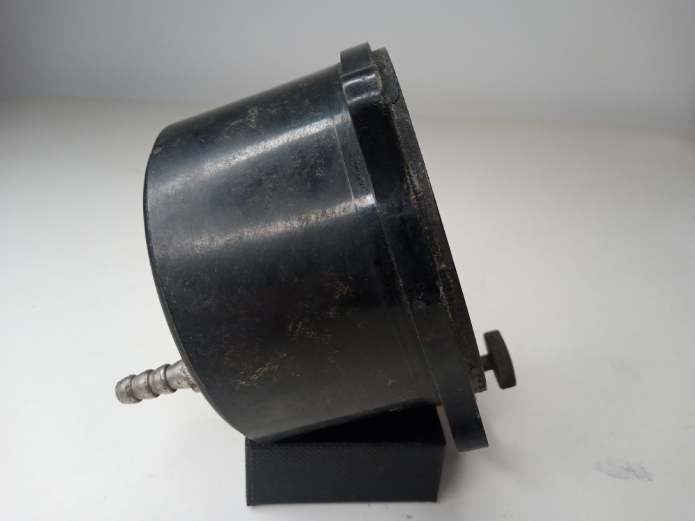 A square black metal Second World War German Luftwaffe aircraft altimeter gauge featuring white dial numbers from zero to five and a central adjustment knob. View V