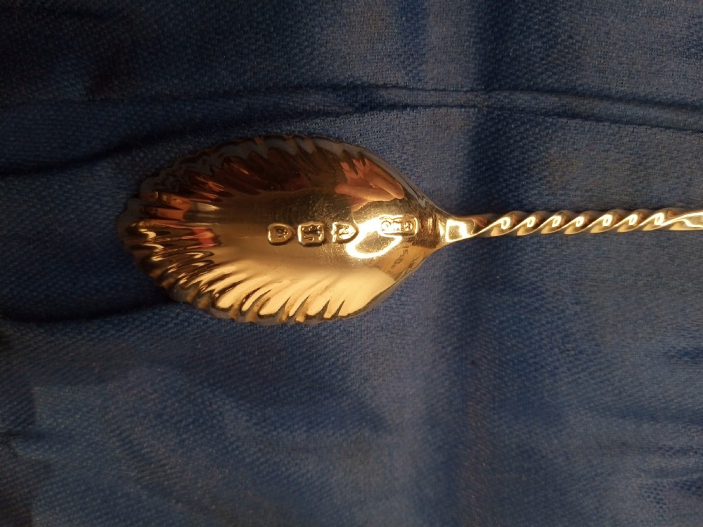 A boxed set of six late nineteenth-century sterling silver coffee spoons with fluted shell-shaped bowls set against a blue fabric lining. View IV