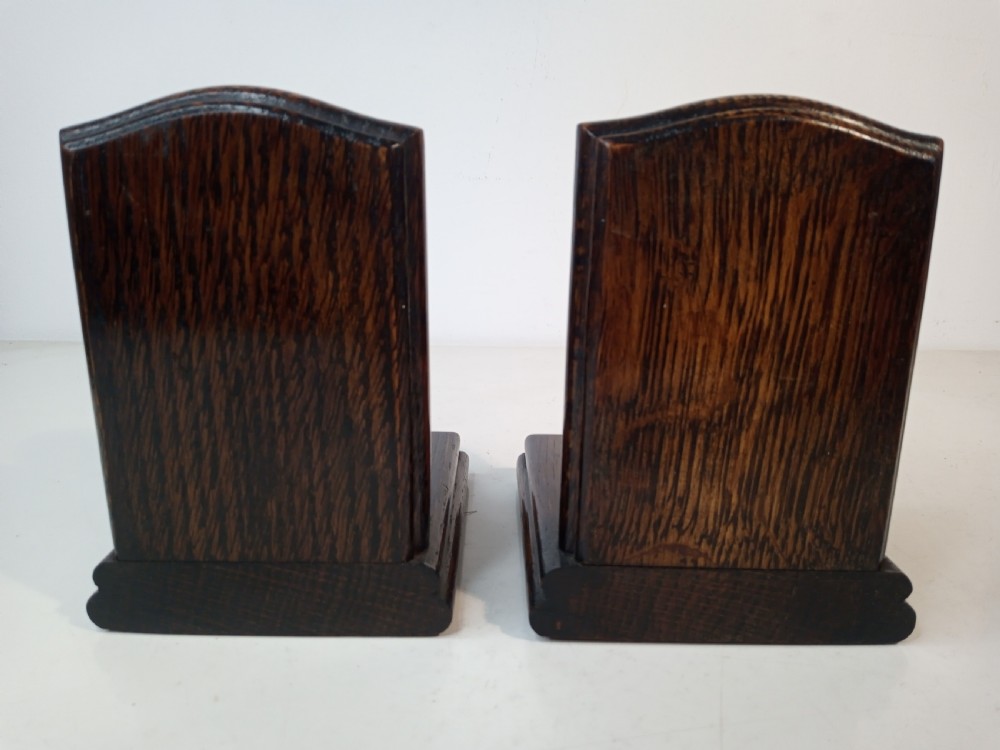 A pair of Art Deco bookends featuring metal busts of William Shakespeare mounted on dark oak bases. View III