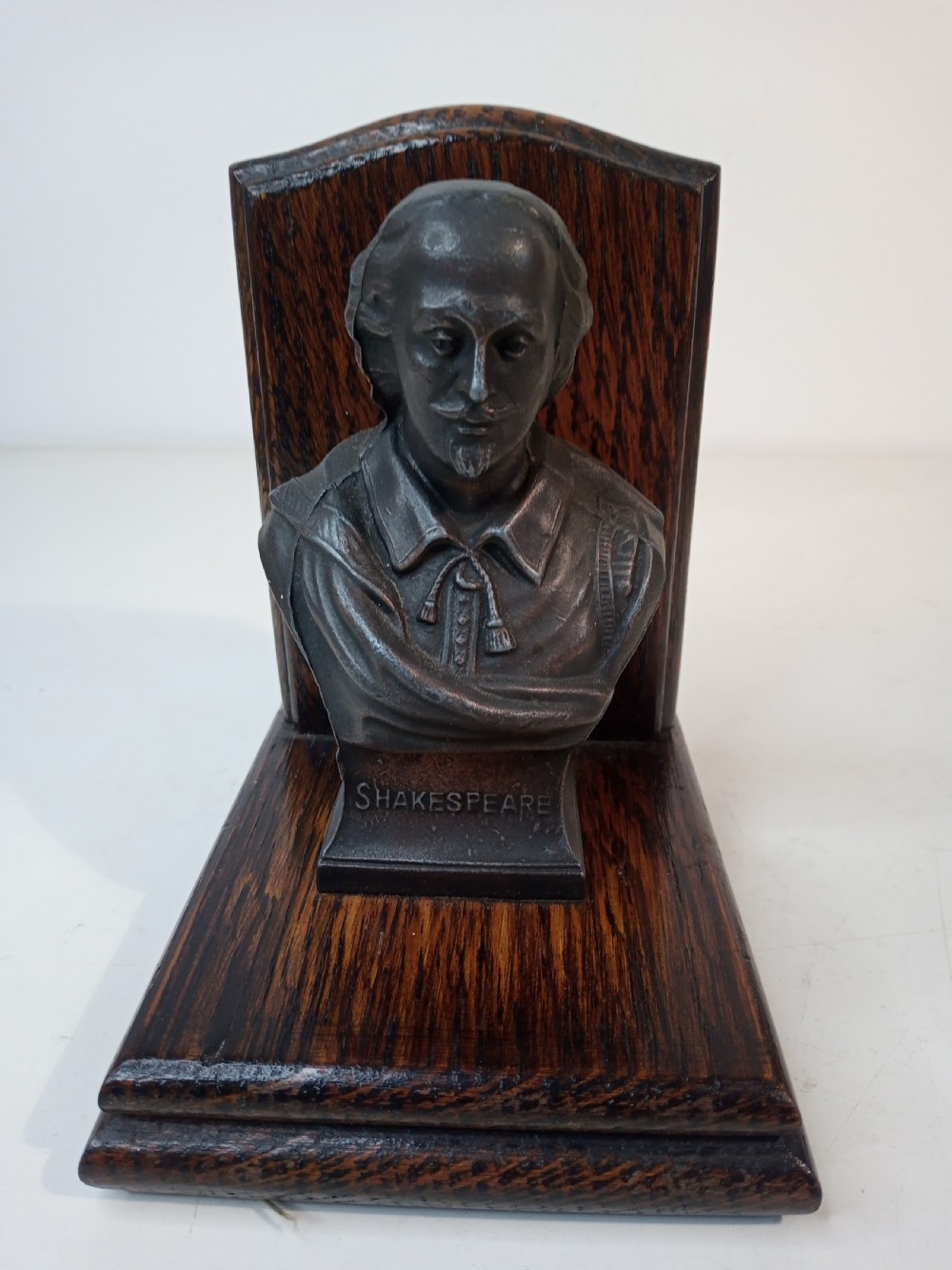 A pair of Art Deco bookends featuring metal busts of William Shakespeare mounted on dark oak bases. View IV