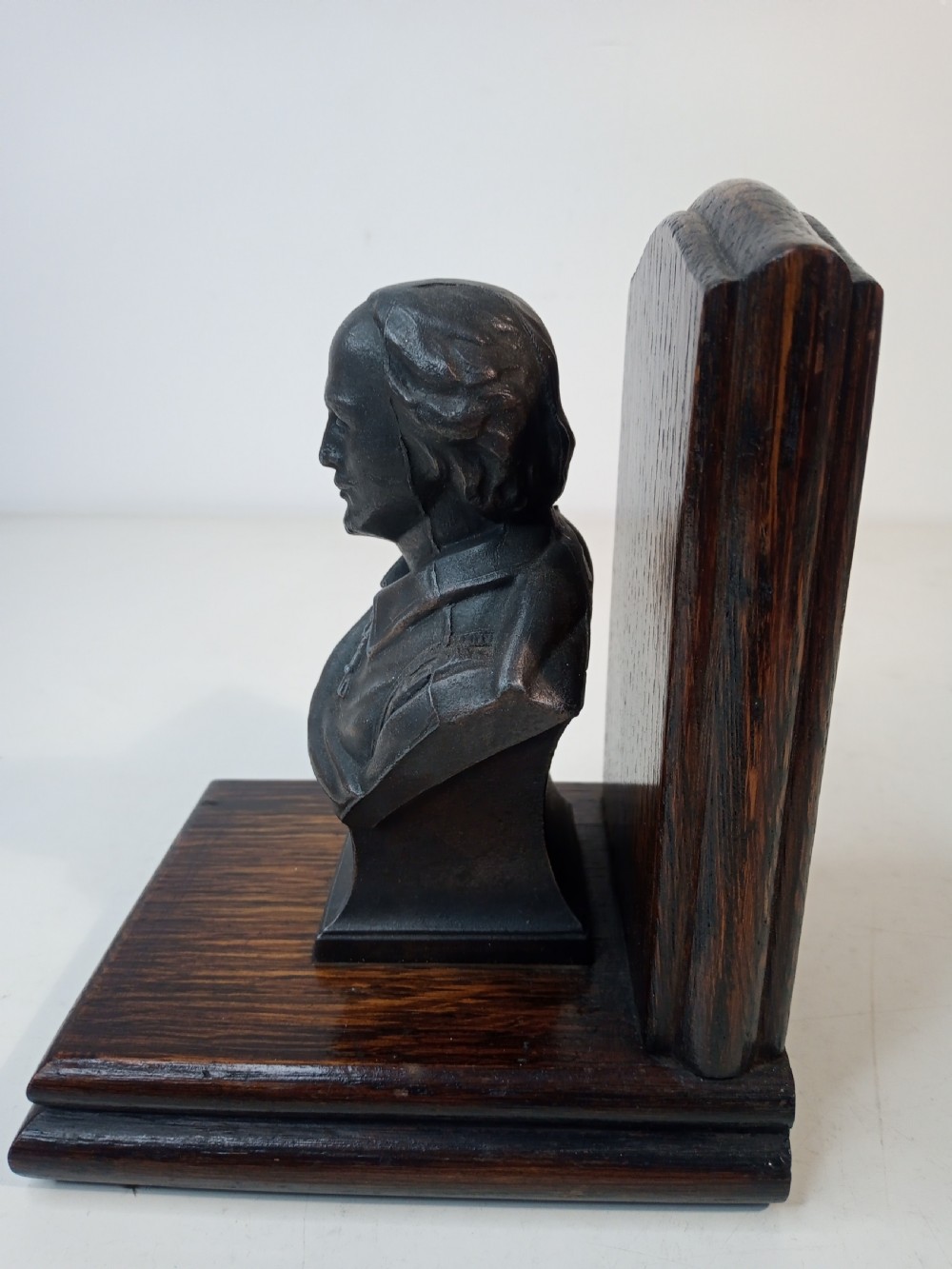 A pair of Art Deco bookends featuring metal busts of William Shakespeare mounted on dark oak bases. View VI