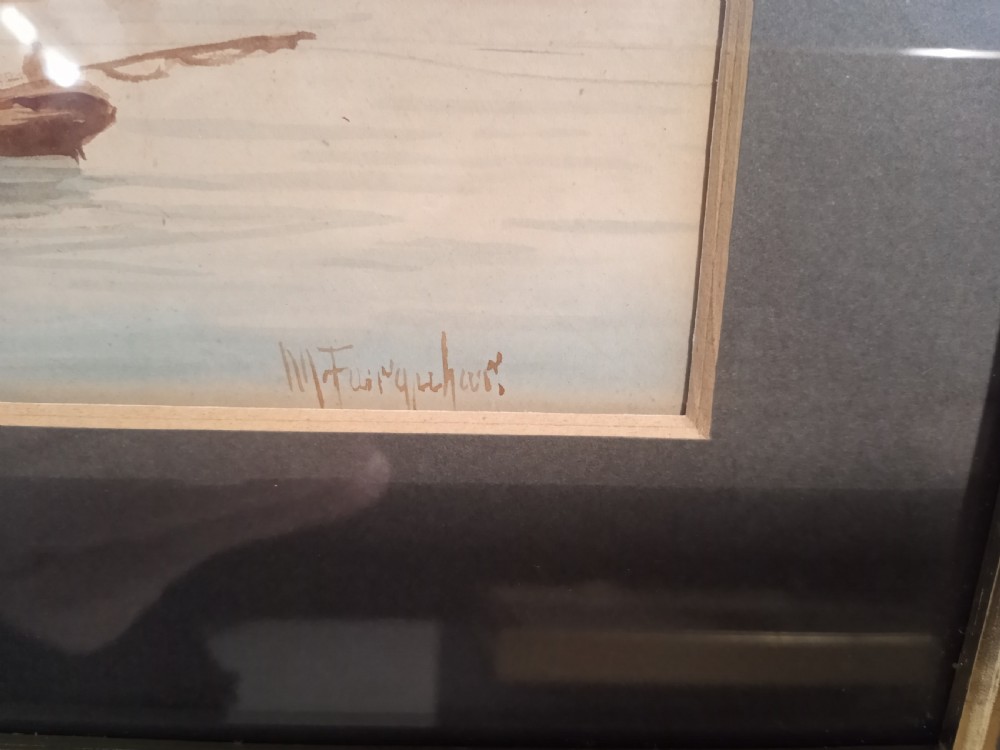 A horizontal nineteenth-century Victorian watercolour painting depicting reddish-brown sailing vessels on calm blue water with a distant lighthouse, housed in a double mount and wooden frame. View IV