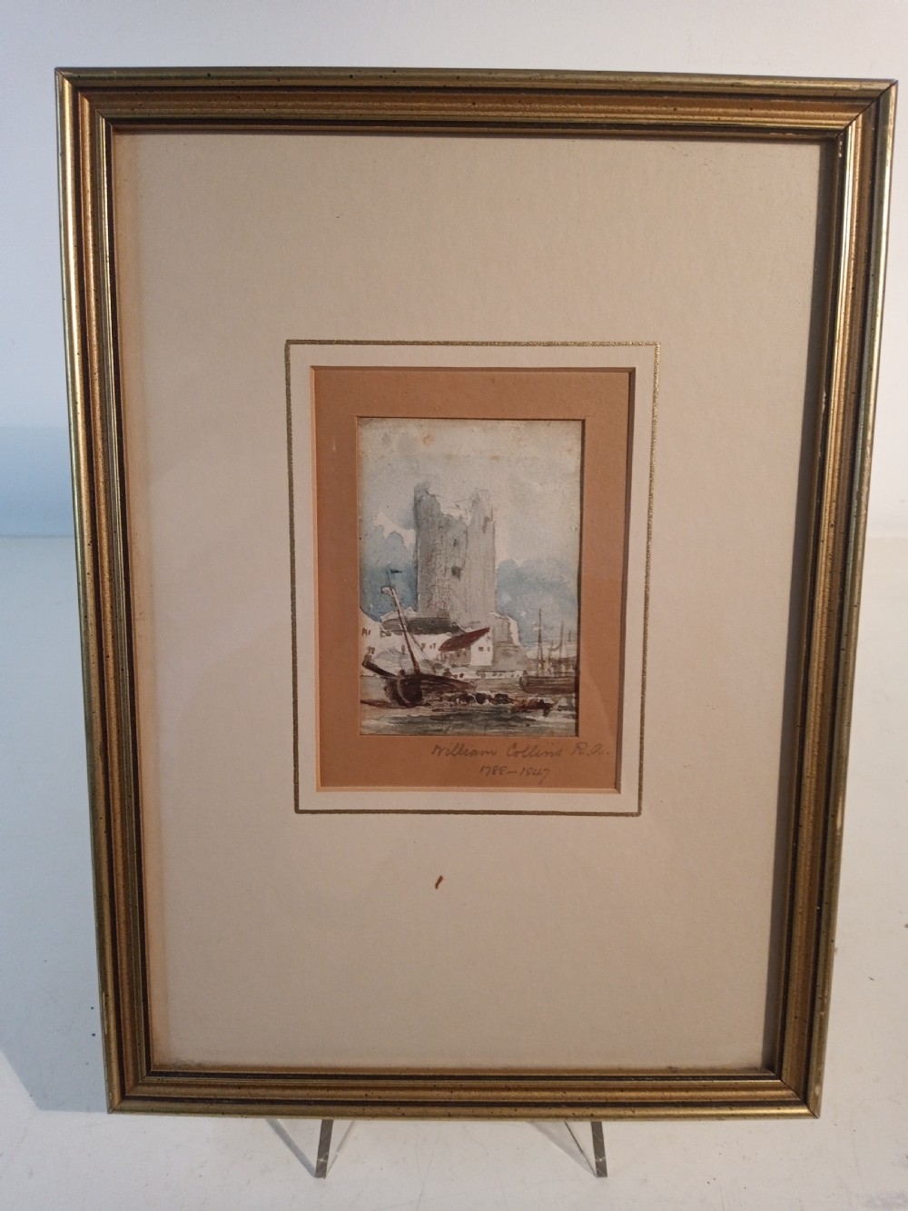 A 19th-century watercolour painting depicting a tall stone ruin alongside a harbour with boats in muted blue, grey, and brown tones. View II