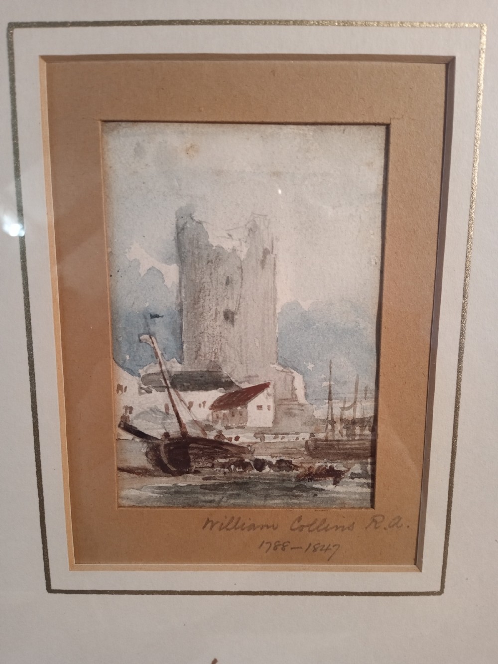 A 19th-century watercolour painting depicting a tall stone ruin alongside a harbour with boats in muted blue, grey, and brown tones. View III