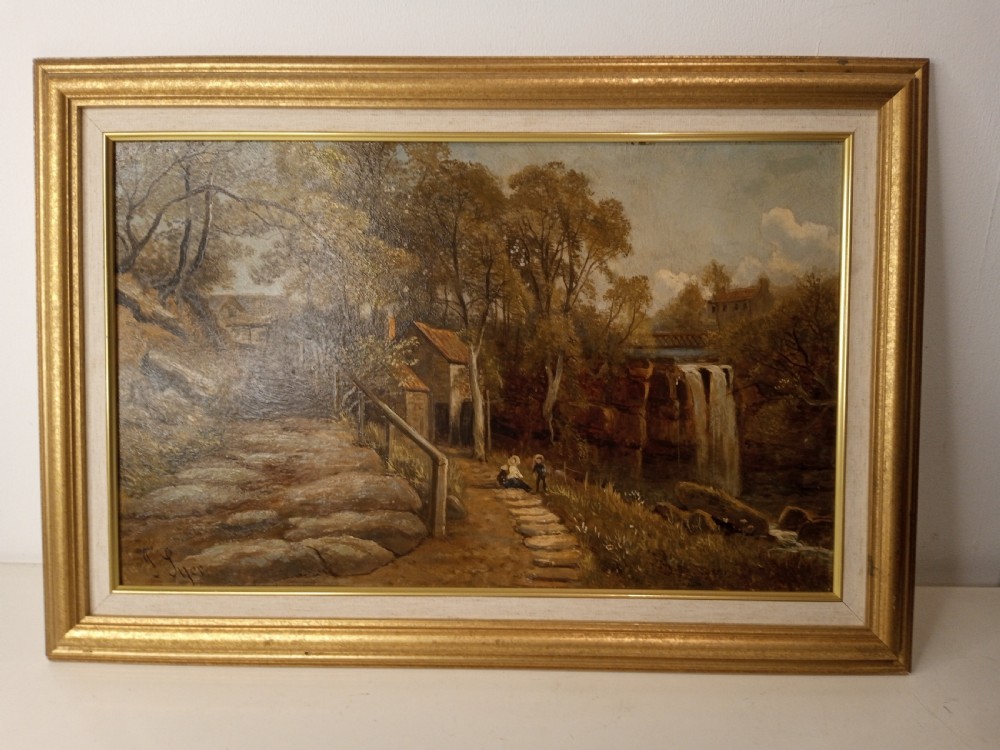 A framed Victorian landscape oil painting depicting a waterfall, a stone path, a cottage, and figures, enclosed within a gilt wood frame.