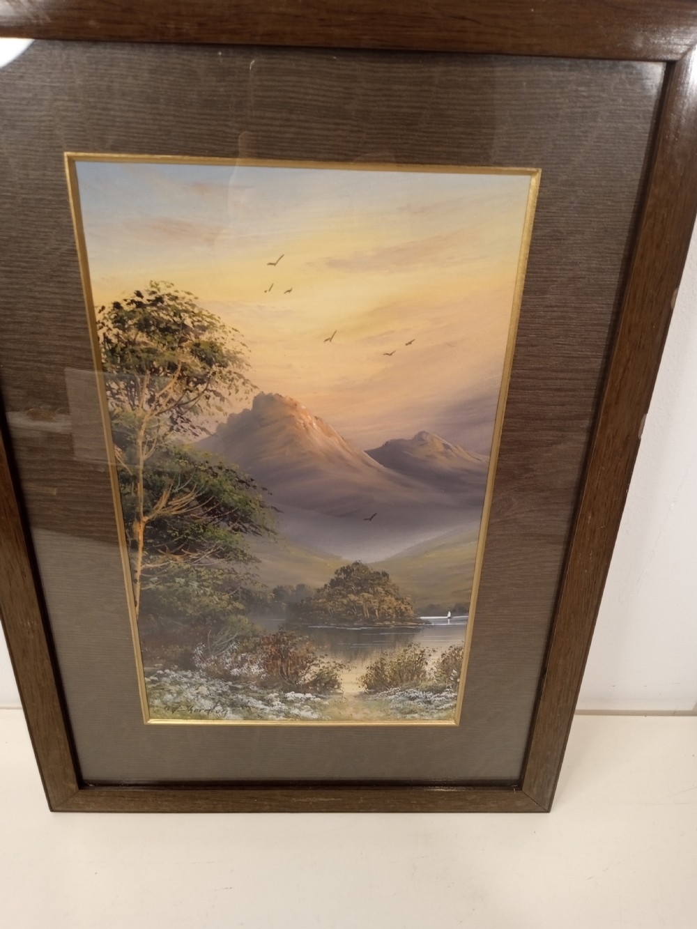 A pair of framed early 20th-century gouache landscape paintings depicting mountainous scenes with bodies of water framed in dark wooden mounts and frames. View IV