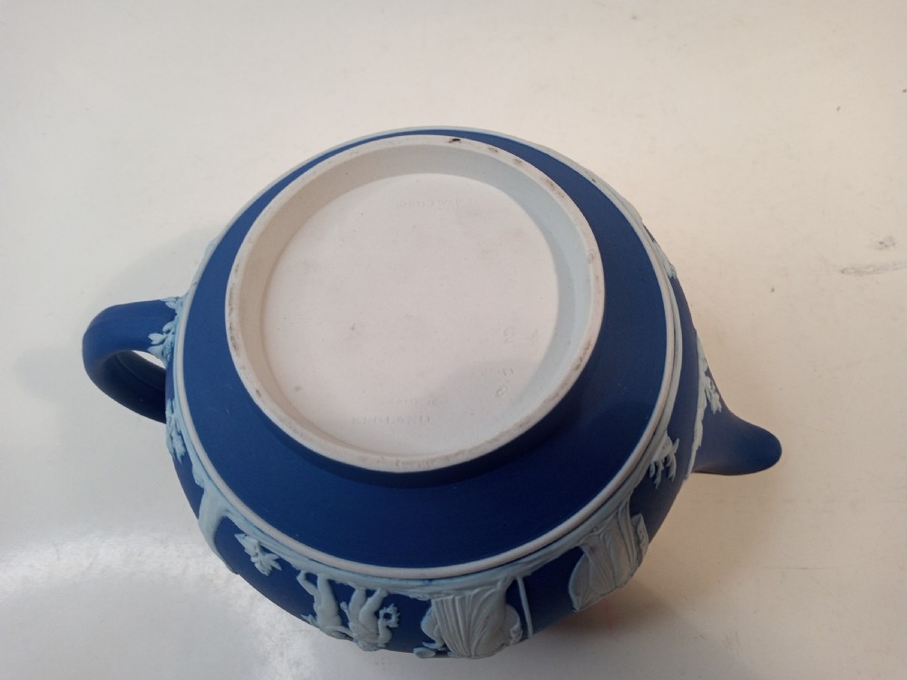 A blue stoneware teapot featuring white neoclassical bas-relief figures and a silver collar around the rim. View VIII