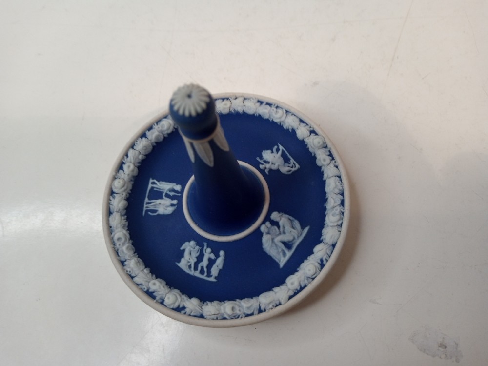 A dark blue Wedgwood jasperware heart-shaped tray alongside a matching circular ring stand featuring white classical bas-relief motifs. View II