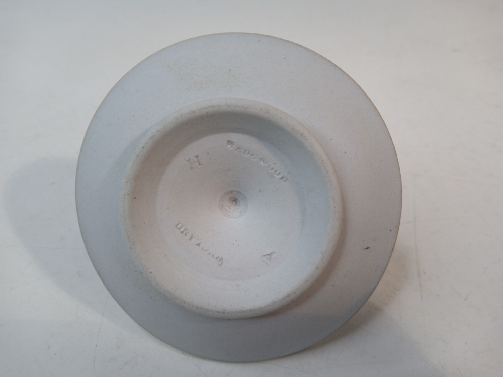 A dark blue Wedgwood jasperware heart-shaped tray alongside a matching circular ring stand featuring white classical bas-relief motifs. View III