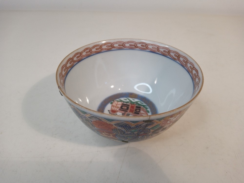 A four-piece Japanese Imari porcelain set featuring three patterned display plates and a matching small bowl decorated with European ship motifs in red, blue, and gold. View VIII