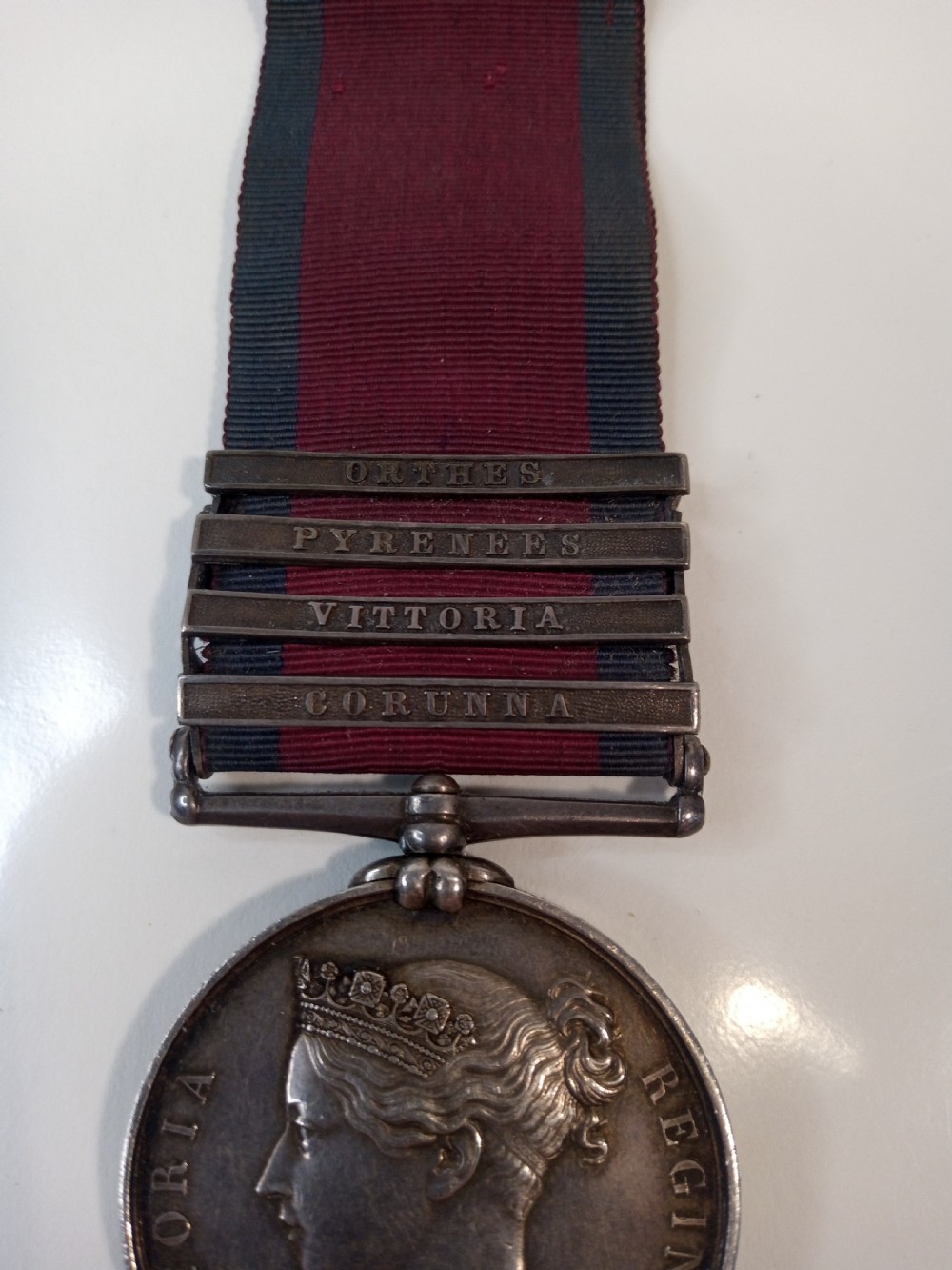 A Victorian silver Military General Service Medal dated 1848 featuring four campaign clasps and Queen Victoria profile on a crimson and blue ribbon. View III