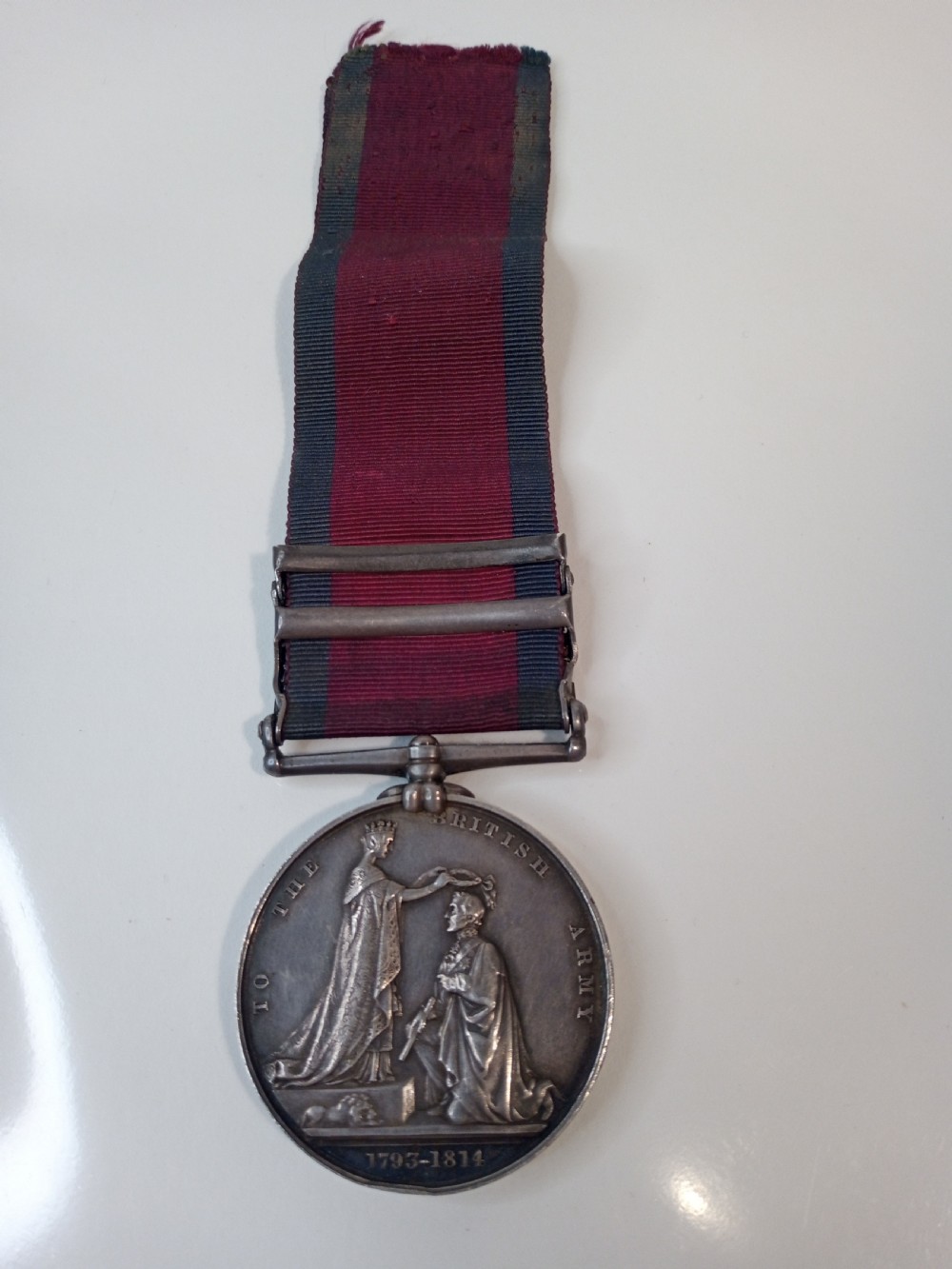 A Victorian silver Military General Service Medal dated 1848 featuring four campaign clasps and Queen Victoria profile on a crimson and blue ribbon. View IV