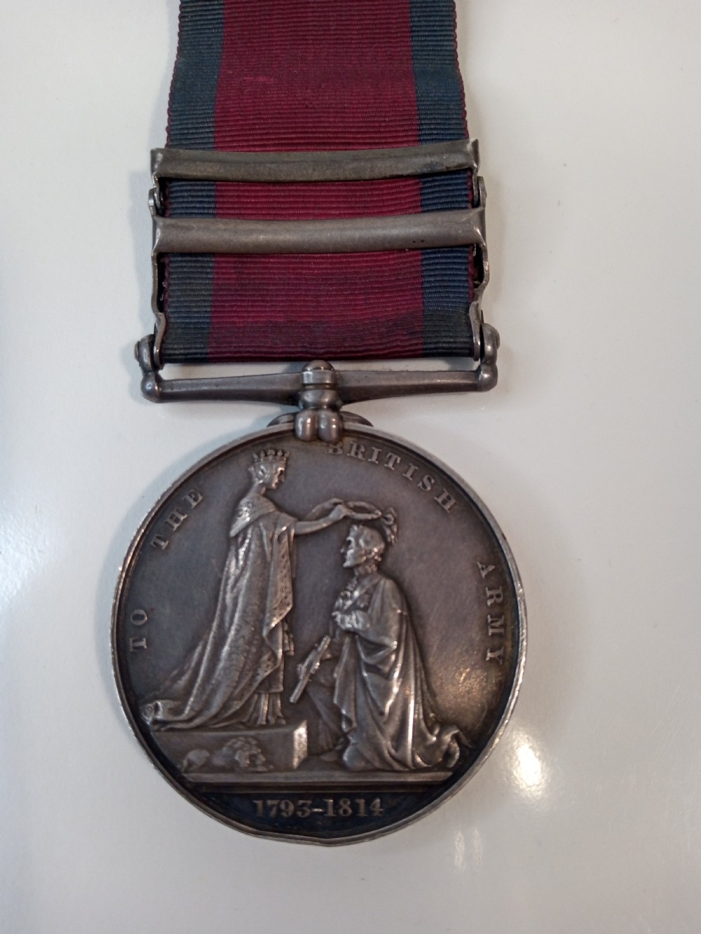 A Victorian silver Military General Service Medal dated 1848 featuring four campaign clasps and Queen Victoria profile on a crimson and blue ribbon. View V