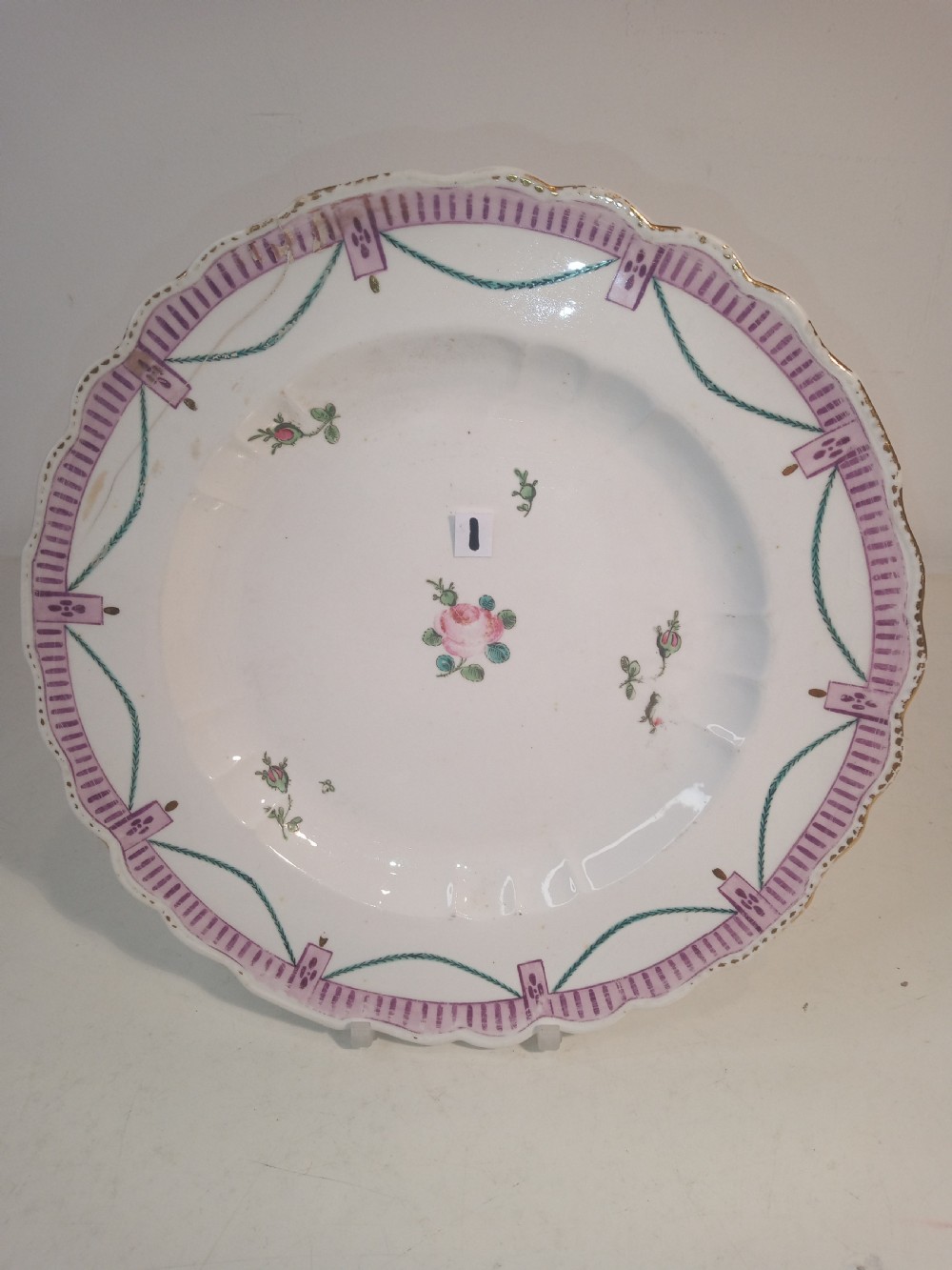 A set of five mid-18th-century Georgian Chelsea soft-paste porcelain plates and shallow bowls decorated with painted floral sprays and pink diaper borders. View IV