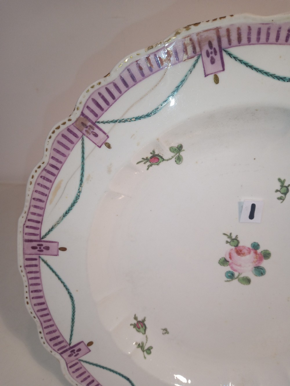 A set of five mid-18th-century Georgian Chelsea soft-paste porcelain plates and shallow bowls decorated with painted floral sprays and pink diaper borders. View V