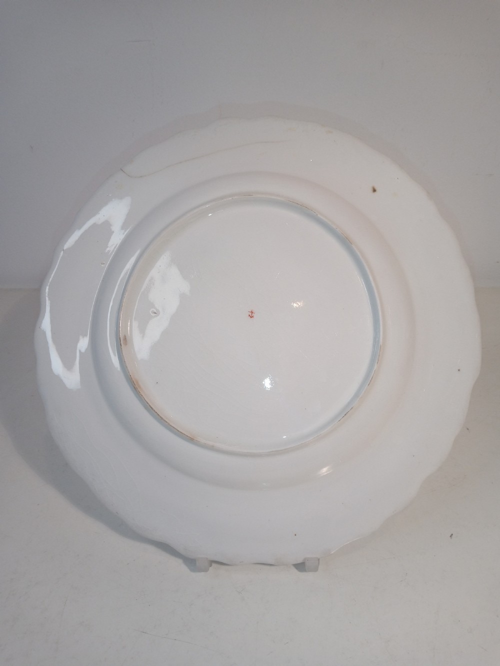 A set of five mid-18th-century Georgian Chelsea soft-paste porcelain plates and shallow bowls decorated with painted floral sprays and pink diaper borders. View VI