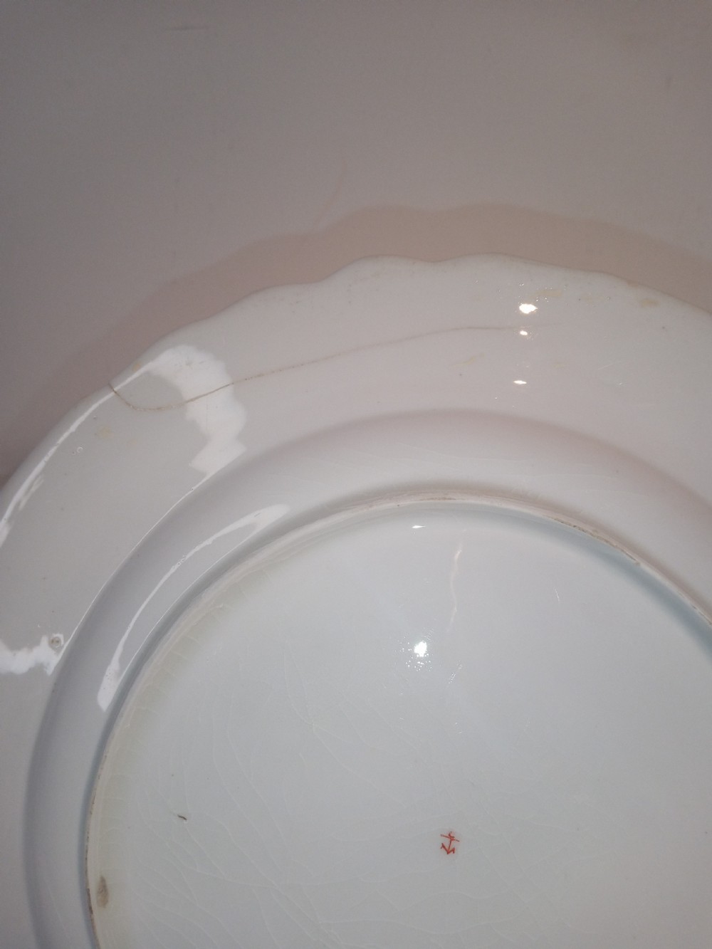 A set of five mid-18th-century Georgian Chelsea soft-paste porcelain plates and shallow bowls decorated with painted floral sprays and pink diaper borders. View VII