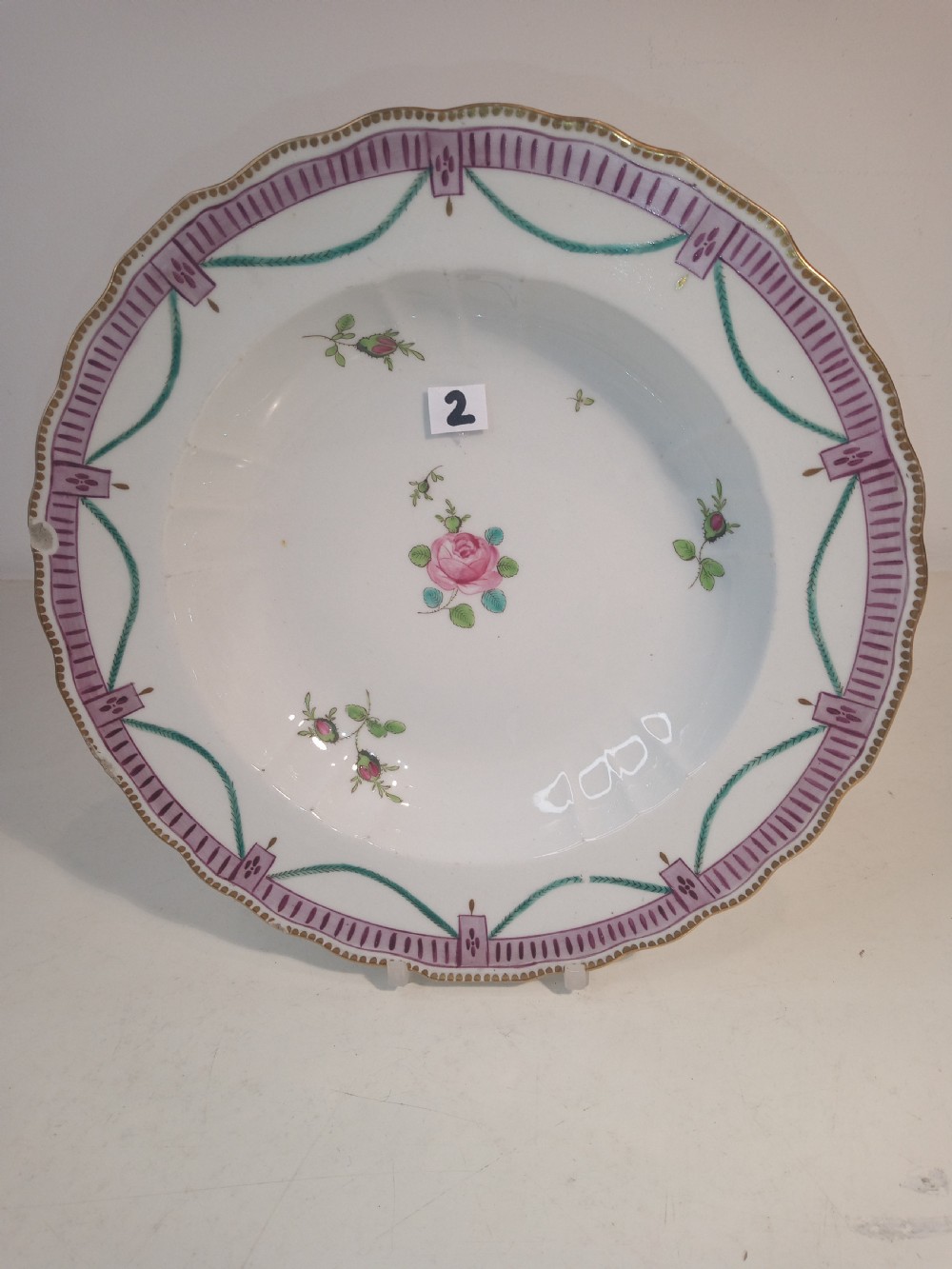A set of five mid-18th-century Georgian Chelsea soft-paste porcelain plates and shallow bowls decorated with painted floral sprays and pink diaper borders. View IX